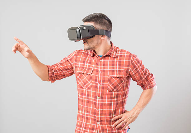 istock Man with virtual reality glasses showing gesture 635477686