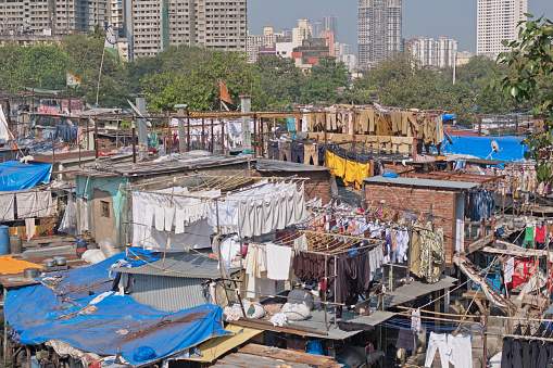 Dhobi Ghat, the open air laundry next to Mahalaxmi station in southern Mumbai, India. Reputed to be the largest of its kind in the world, it employs handwashers, known as Dhobi Wallahs, in over one thousand concrete pens dealing with the laundry of a large section of Mumbai's residents