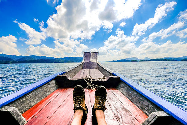 istock Male's feet relaxing on a boat. 635480106