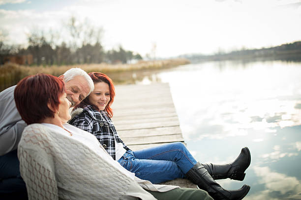istock Happy family on lake pier 635670990