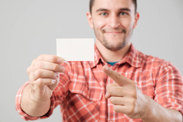 istock Man showing blank business card 635671368