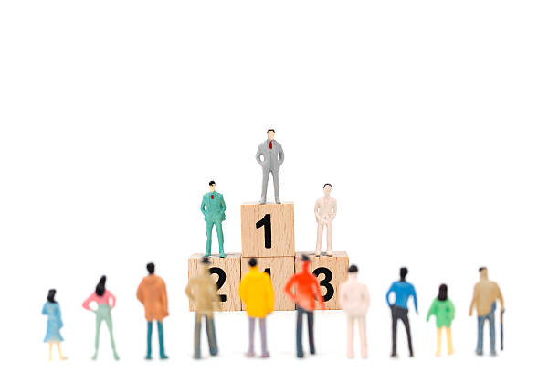 istock Group of miniature businessman on white background 635671680