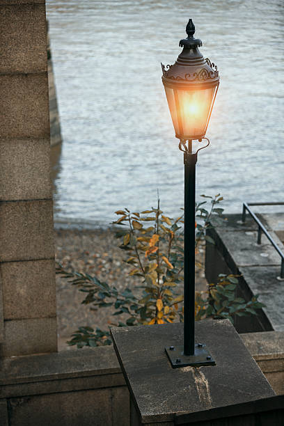istock Glowing small street light near river 635671916