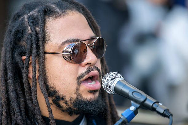 istock Cool singer with dreadlocks in front of mike 635672292