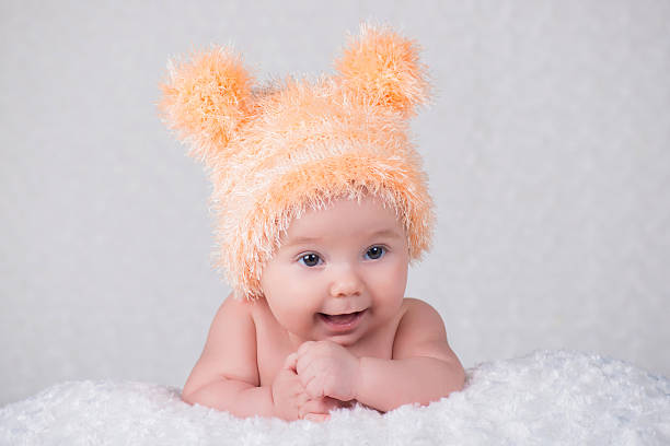 istock Newborn baby in a knitted cap with ears. 635675992