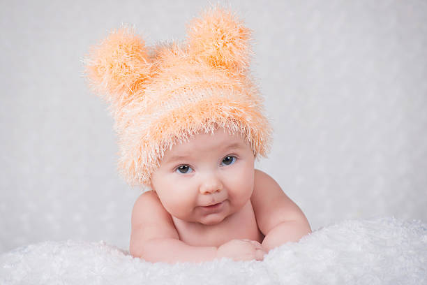 istock Newborn baby in a knitted cap with ears. 635676046