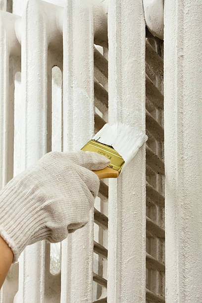 istock painting radiator central heating with brush 635680990