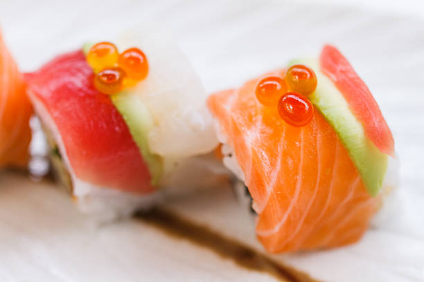 Maki Roll that Rolled with Salmon, Avocado and Maguro (Tuna) Topping with Tobiko. Inside include Japanese Steamed Rice, Seaweed, Cucumber and Kani.
