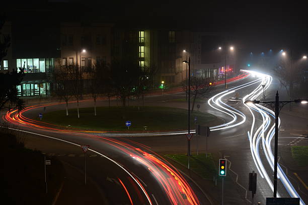 Long exposure of traffic in St.Helier at night with slight fog, and traffic light trails.