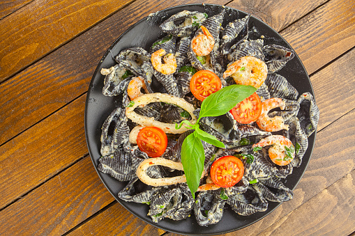 delicious fresh Italian pasta Neri on plate with shrimp