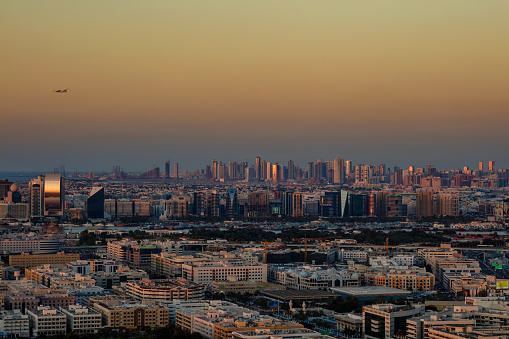 Dubai, UAE - February 18, 2016: A skyline view of Deira Dubai, UAE and Sharjah as viewed from Dubai Frame at sunset