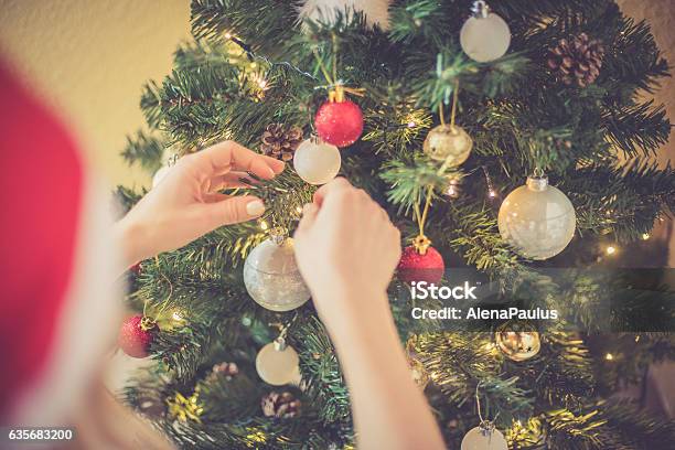 Regional Christmas At Home Blonde Woman Decorating Xmas Tree Stock Photo - Download Image Now