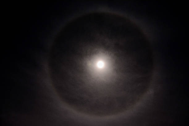 istock Full moon in a cloudy sky with halo 635697040