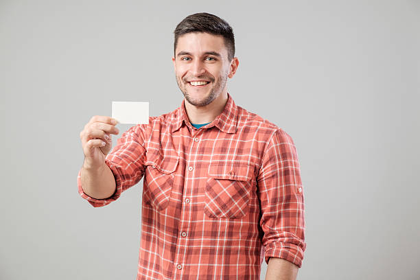 istock Man showing blank business card 635697388