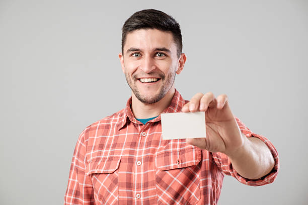 istock Man showing blank business card 635697462