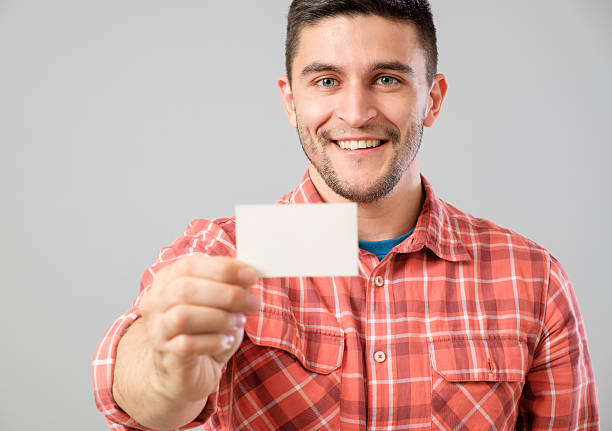 istock Man showing blank business card 635697620