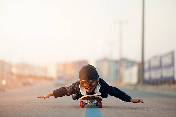 istock Young Boy Imagines Flying On Skateboard 635698132