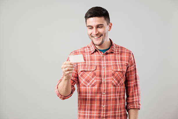 istock Young man reading business card 635698774