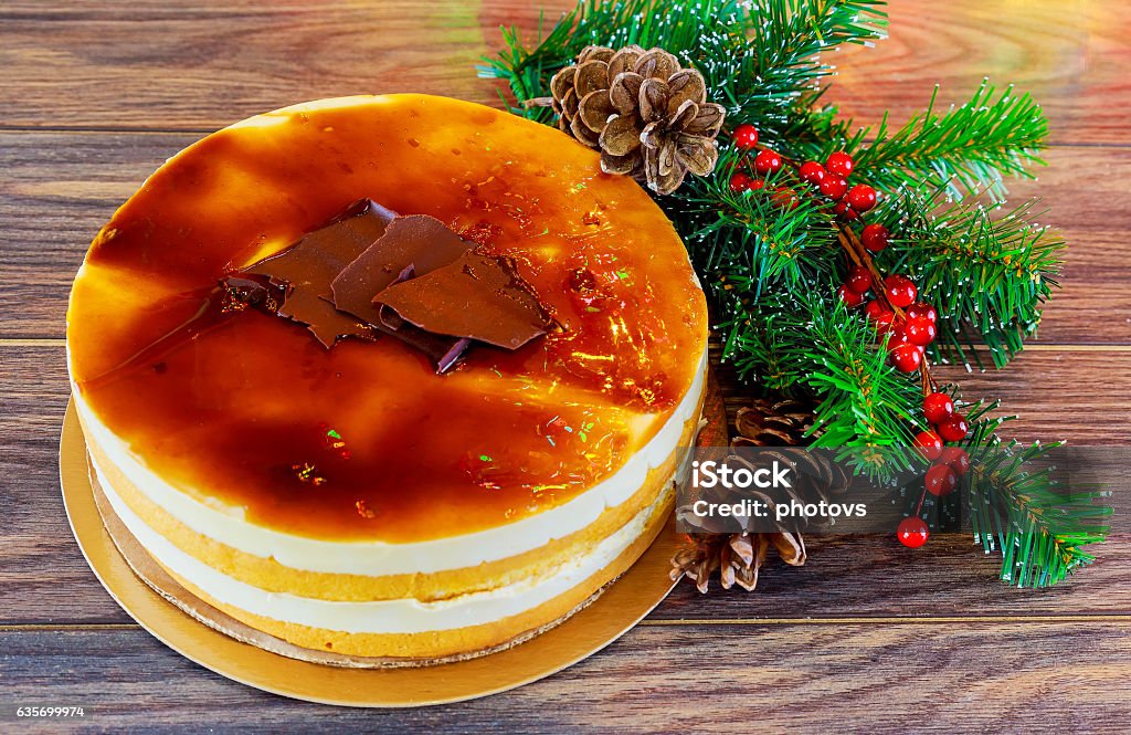 Christmas composition.  cake  New Year decoration Christmas composition. Christmas cake pan de pasqua, red mug of tea and Christmas New Year decoration - fir brunches, fir and pine cones, New Year balls, red napkin on black background Baked Stock Photo