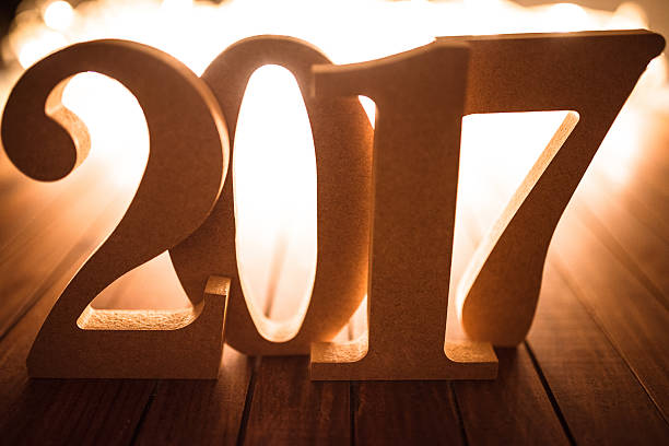 istock 2017 new year on plank wood with christmas lights 635701382
