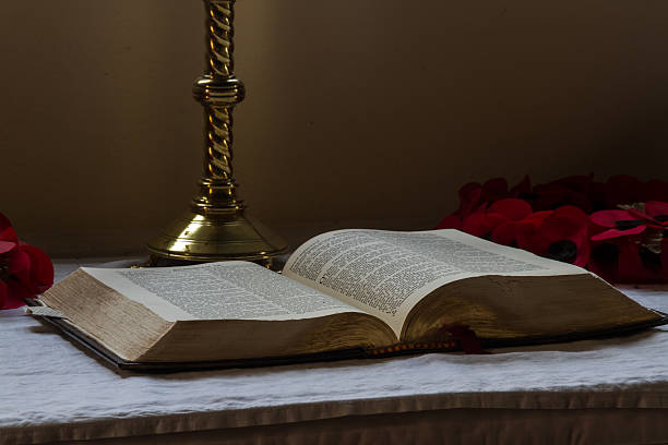 Old bible open on altar with candlestick