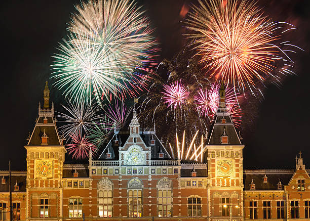 Fireworks above the Amsterdam Centraal Fireworks above the Amsterdam Centraal, the main downtown metro and train station new year urban scene horizontal people stock pictures, royalty-free photos & images