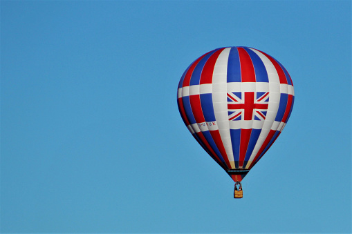 Albuquerque, NM, USA - October 7, 2016: Hot air balloon with Union Jack soars against pale blue sky during Balloon Fiesta 2016.