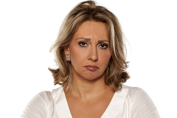 istock sad middle-aged woman on a white background 635717774