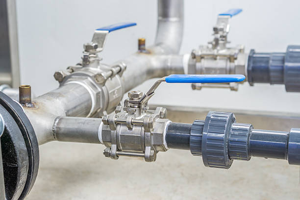 stainless ball valves in the pipes. - valve imagens e fotografias de stock