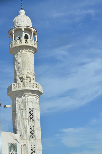 Mosque minaret with blue sky in the background
