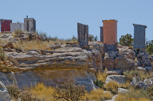 Since Acoma Pueblo is on a mesa overlooking the desert and there is no running water or electricity there, it stands to reason that the 30 residents who live there year round would need bathroom facilities.  Well, here they are!  Several outhouses (one with the sliver of a moon on its door) stand at the edge of the mesa...I guess everything runs downhill from there!