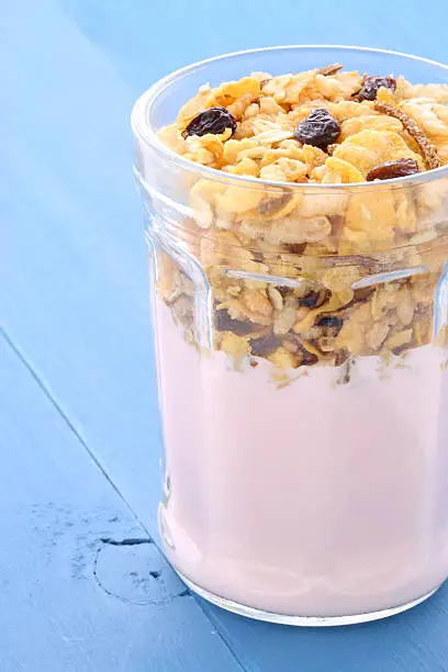 delicious healthy parfait made with creamy yogurt and crunchy granola or muesli on vintage country styling.