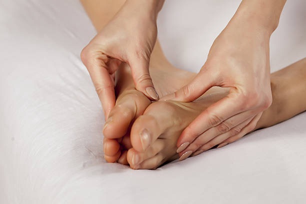 istock young woman massaging her tired feet 635724024