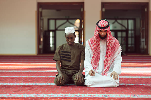 istock Two religious muslim man praying together inside the mosque 635726318