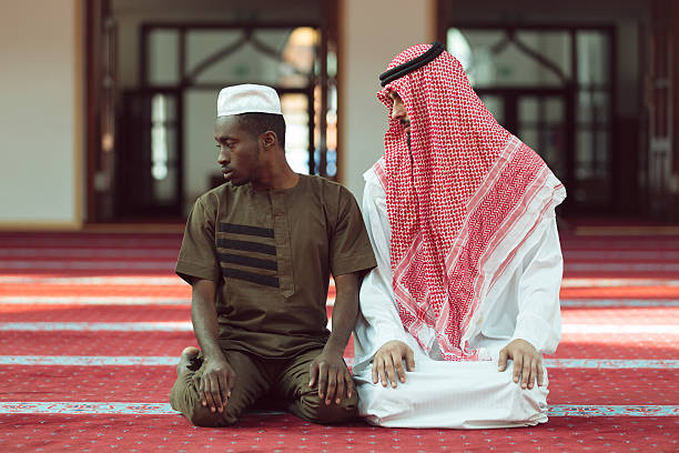 istock Two religious muslim man praying together inside the mosque 635726380