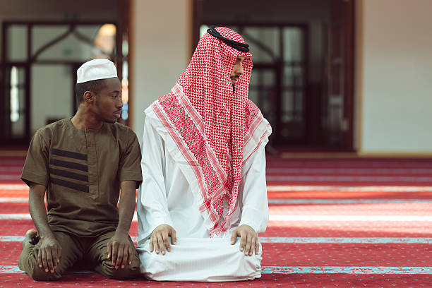 istock Two religious muslim man praying together inside the mosque 635726396