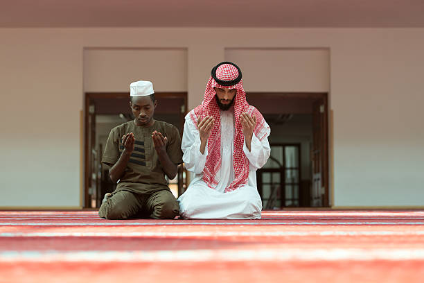 istock Two religious muslim man praying together inside the mosque 635726426
