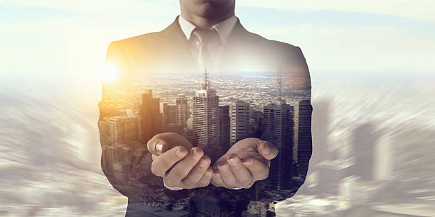 istock Businessman against modern city background . Mixed media 635728916