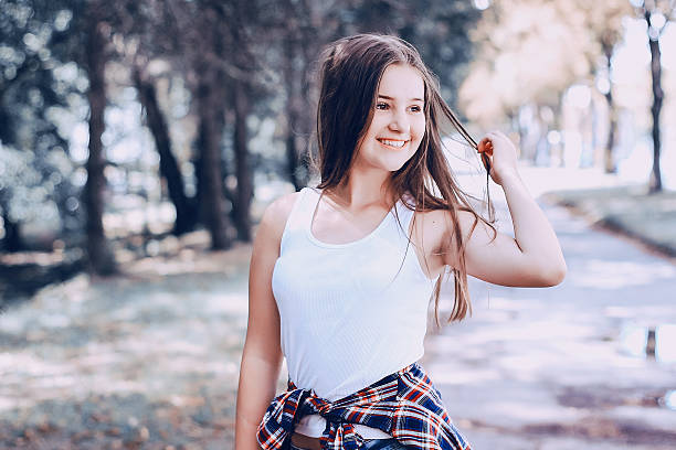 istock young beautiful girl walking park 635729720