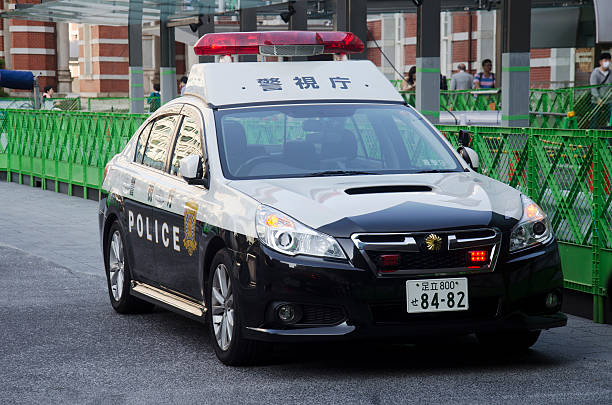 首都　POLICE　JAPAN Japanese Policemen People Driving Cop Car On The Road Stock Photo