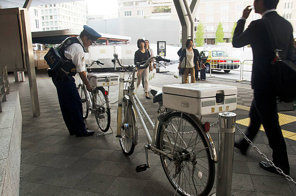 Tokyo, Japan - October 20, 2016: Japanese policemen people stopping bicycle after bike bicycles check over everything on traffic road at JR tokyo station on October 20, 2016 in Tokyo, Japan