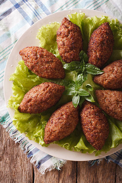 istock Arabic beef meatballs kibbeh close-up on plate. vertical top view 635732392