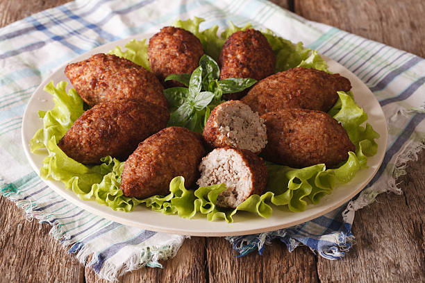 istock Arabic meat appetizer kibbeh close-up on a plate. horizontal 635732604