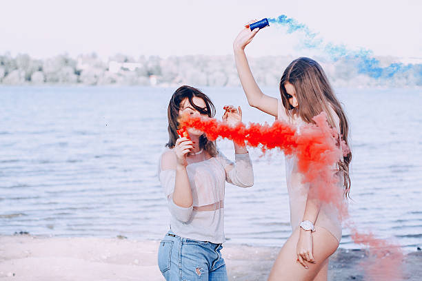 istock two girls resting on the beach 635732714