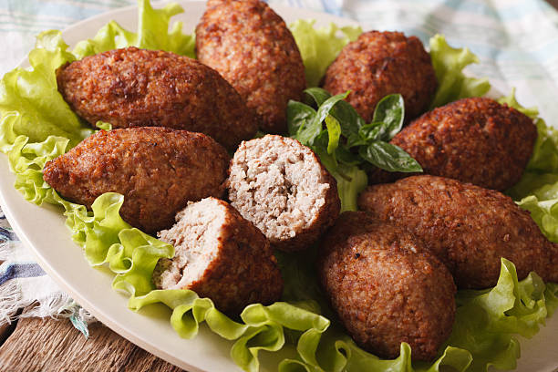 istock Delicious spicy Kubbeh with bulgur, onion and pine nuts macro 635733048