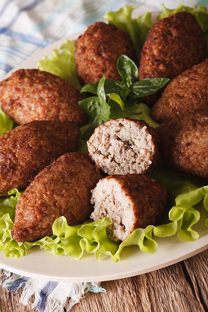 istock Delicious spicy Kubbeh with bulgur, onion and pine nuts macro 635733280