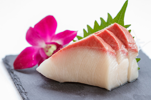 Hamachi Sashimi : Sliced Raw Hamachi (Yellowtail Fish) Served with Sliced Radish on Stone Plate.