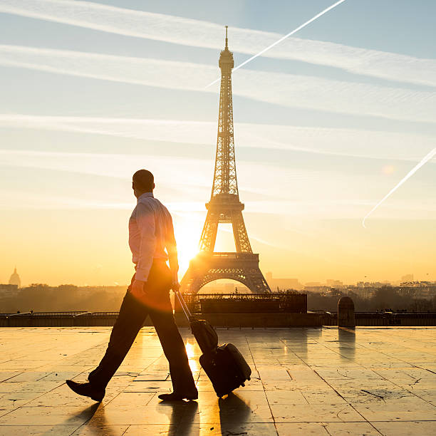 istock Travel businessman walking with suitcase at Eiffel Tower in Paris 635739338