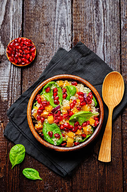 istock Pomegranate sweet potato quinoa spinach salad 635739356
