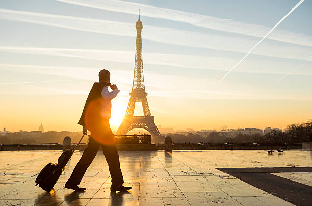 istock Travel businessman walking with suitcase at Eiffel Tower in Paris 635739396